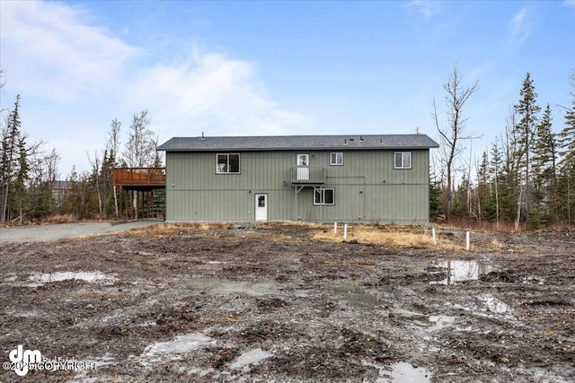 back of property with a wooden deck