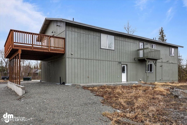 back of property with a carport and a wooden deck