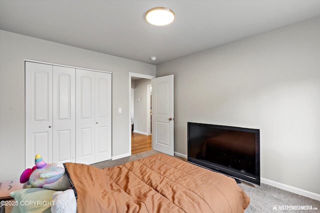 bedroom with carpet floors, a closet, and baseboards