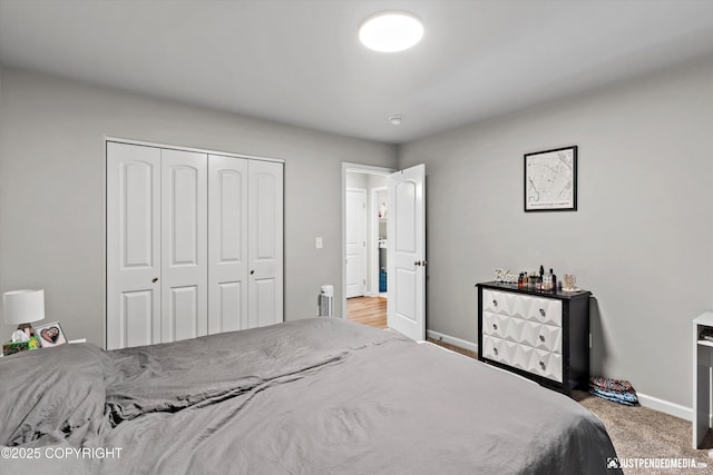 bedroom with carpet, baseboards, and a closet