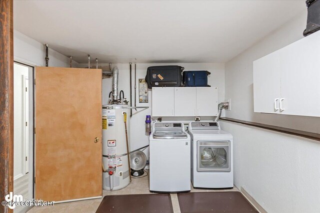 washroom featuring gas water heater, cabinet space, and separate washer and dryer