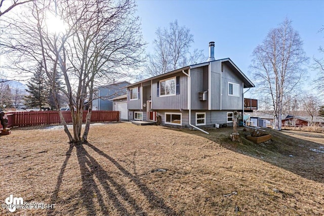 rear view of property featuring fence