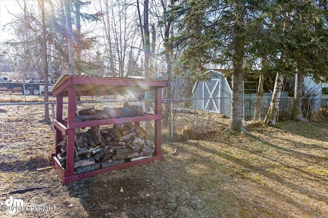 view of yard with an outbuilding, fence, a barn, and exterior structure