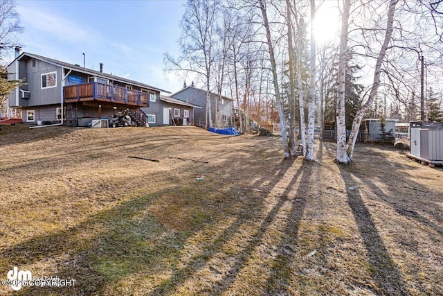 view of yard with a deck and stairs