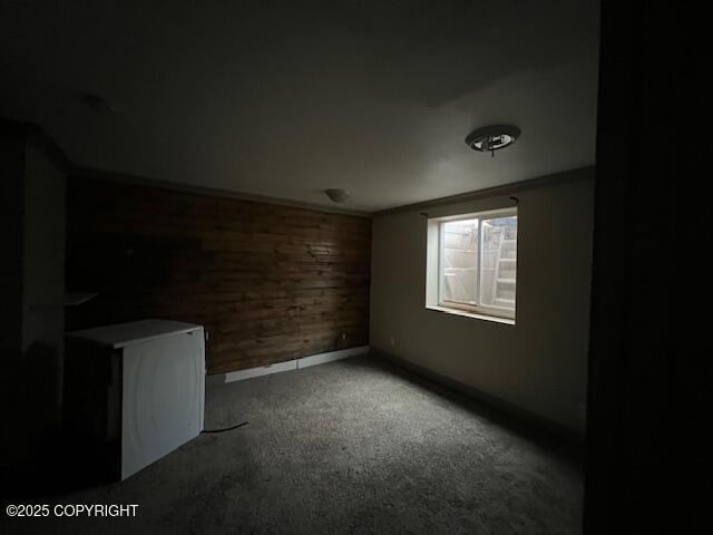 carpeted empty room featuring baseboards