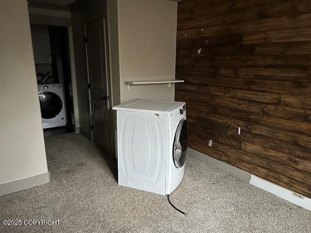 laundry area with washer / dryer, laundry area, and wooden walls