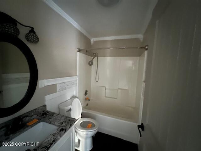 bathroom featuring toilet, shower / tub combination, ornamental molding, and vanity