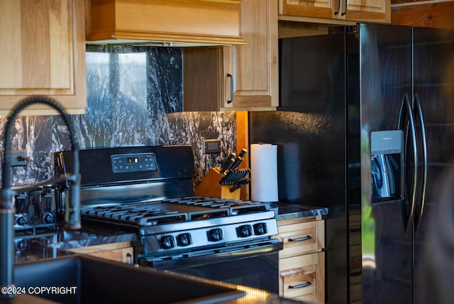 kitchen with black fridge with ice dispenser, decorative backsplash, light brown cabinetry, gas range oven, and dark countertops