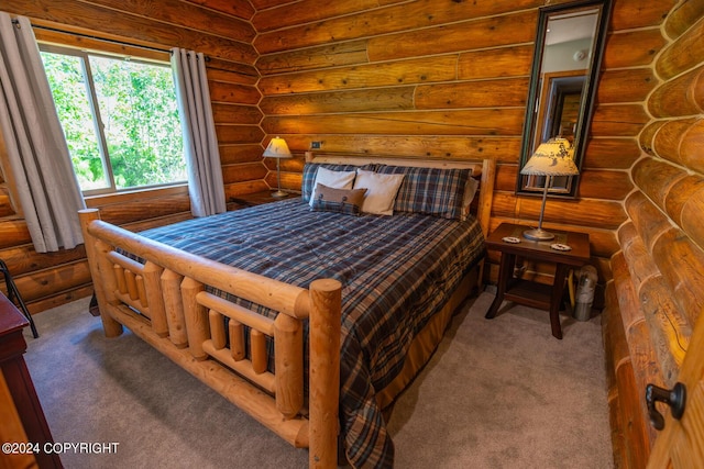 bedroom featuring carpet and rustic walls