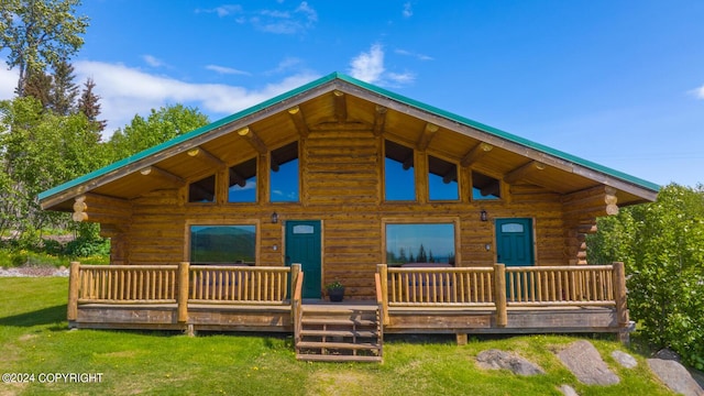 back of property featuring a yard and log exterior