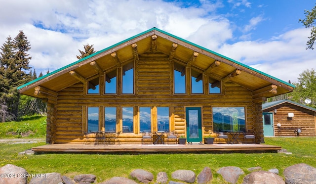 rear view of house featuring log siding