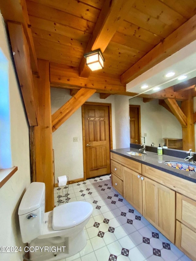 bathroom featuring beamed ceiling, wooden ceiling, a sink, and toilet