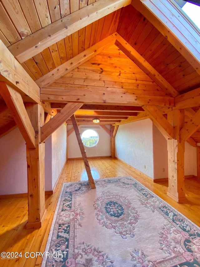 bonus room with lofted ceiling with beams, wooden ceiling, and wood-type flooring