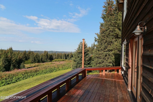 wooden deck featuring a view of trees