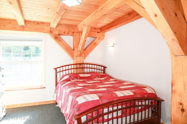 bedroom with carpet floors, beamed ceiling, wooden ceiling, and baseboards