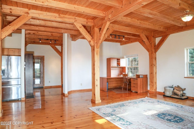 interior space with vaulted ceiling with beams, light wood-style floors, wood ceiling, and rail lighting