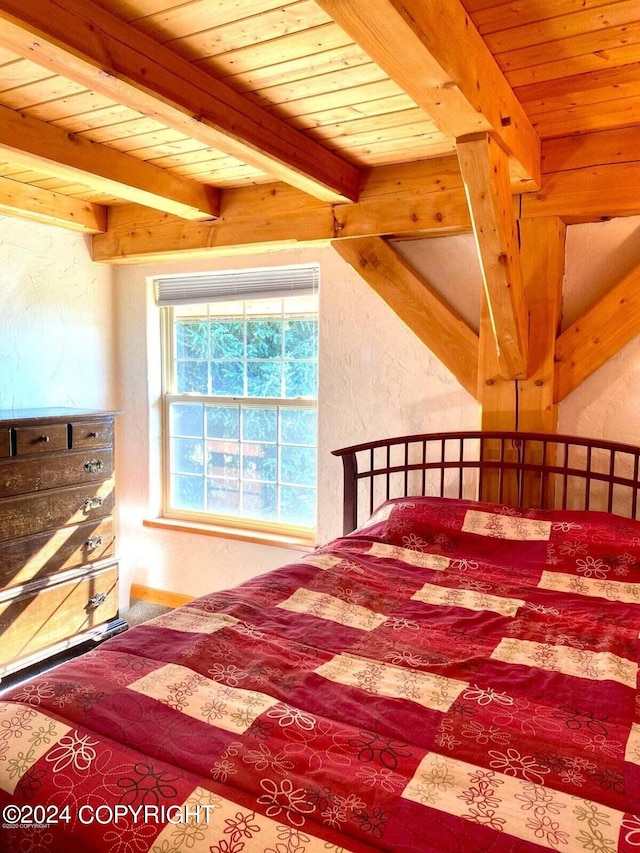 bedroom with a textured wall, wood ceiling, and beamed ceiling