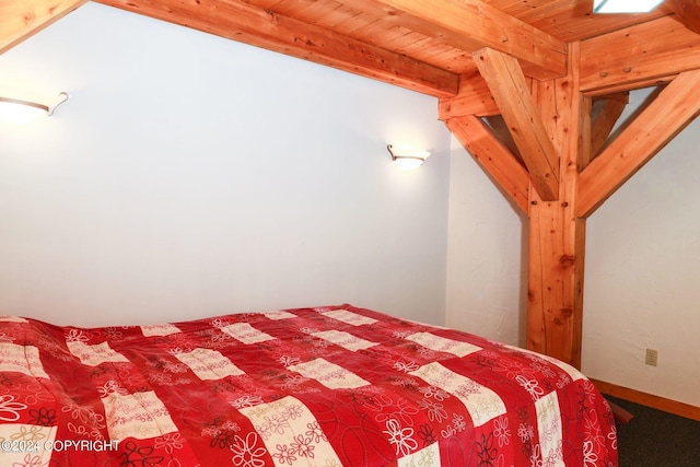 unfurnished bedroom with wooden ceiling and beamed ceiling