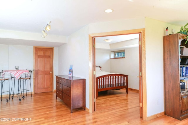 bedroom with light wood-type flooring, baseboards, and recessed lighting