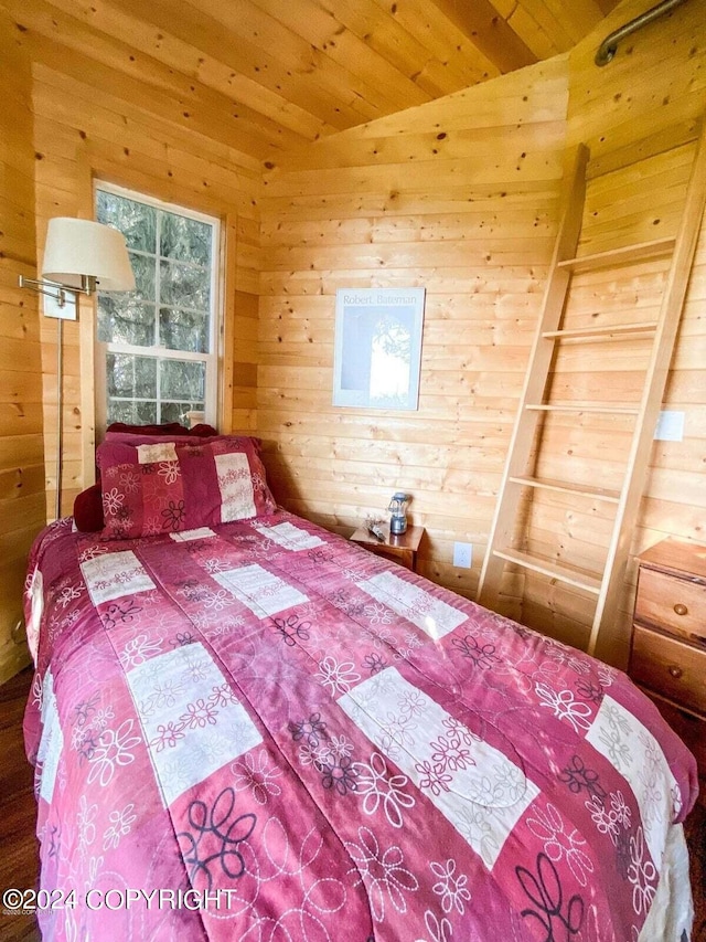 bedroom with wood walls and wood ceiling