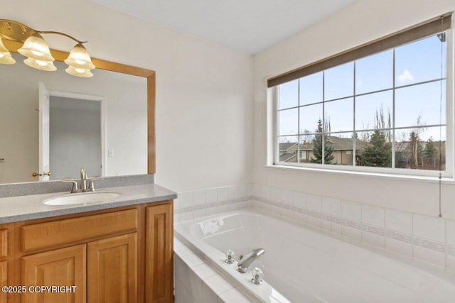 full bathroom featuring a garden tub and vanity