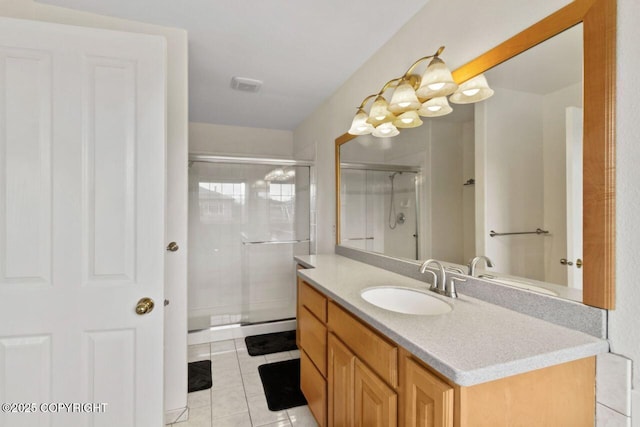 bathroom featuring a shower stall, vanity, visible vents, and tile patterned floors