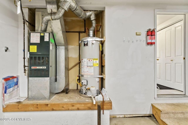 utility room featuring water heater and heating unit