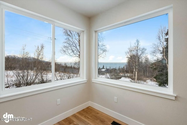 unfurnished sunroom featuring a water view