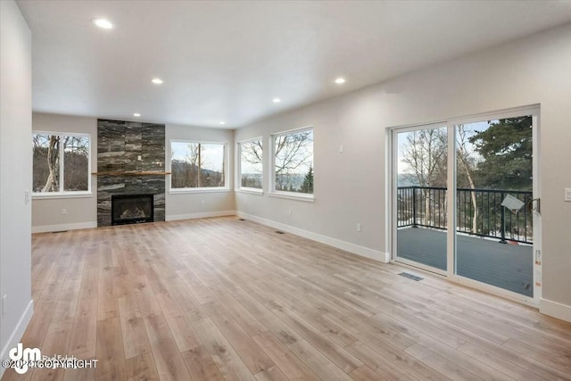 unfurnished living room featuring light wood-style floors, recessed lighting, visible vents, and baseboards