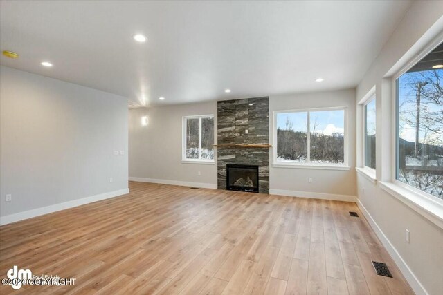 unfurnished living room featuring recessed lighting, baseboards, visible vents, and light wood finished floors