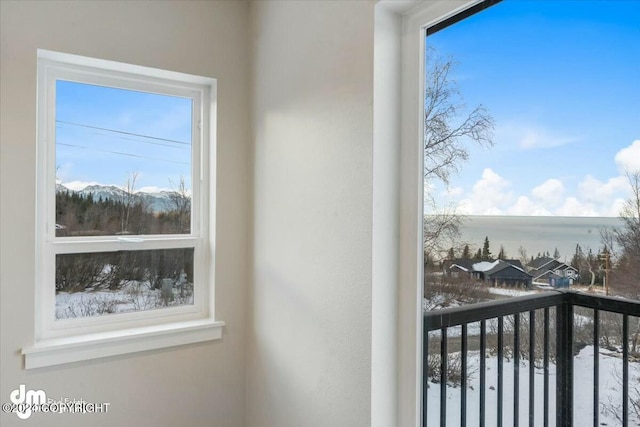 view of snow covered back of property