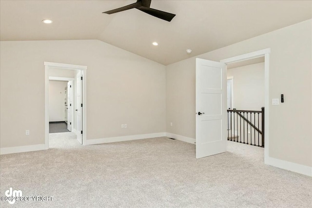 unfurnished room featuring recessed lighting, light colored carpet, vaulted ceiling, ceiling fan, and baseboards