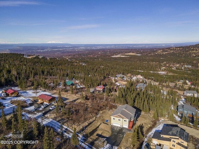 birds eye view of property with a view of trees