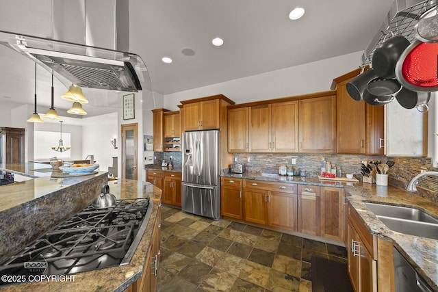 kitchen featuring stainless steel fridge with ice dispenser, brown cabinets, black gas stovetop, exhaust hood, and a sink