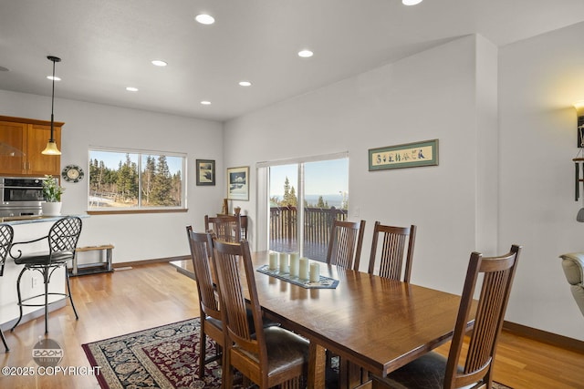 dining room with a wealth of natural light, baseboards, recessed lighting, and light wood finished floors