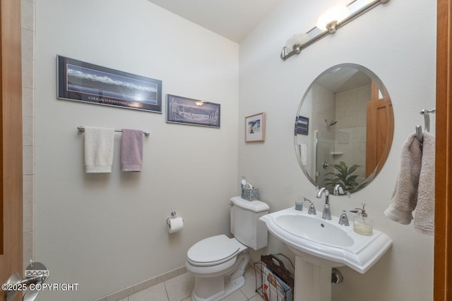 full bathroom featuring tile patterned flooring, toilet, a shower, and baseboards