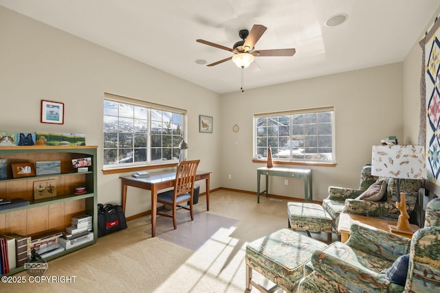 carpeted home office with baseboards, a healthy amount of sunlight, and a ceiling fan