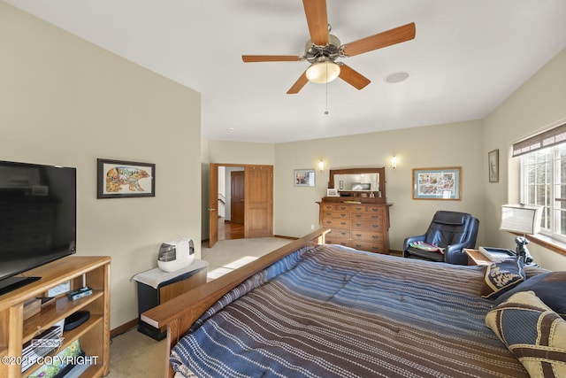 carpeted bedroom featuring baseboards and ceiling fan