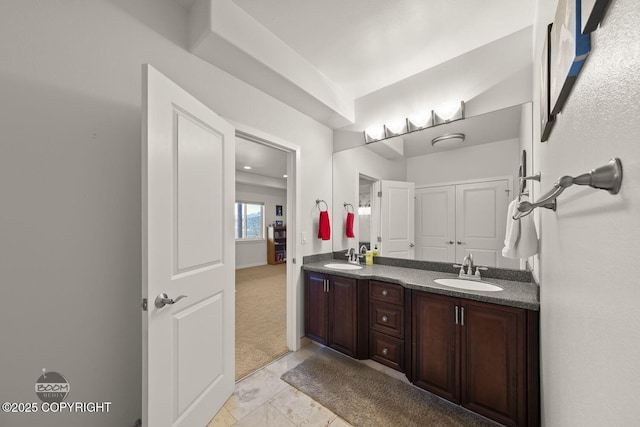 full bath with a sink and double vanity