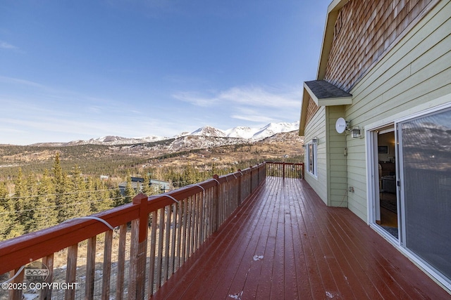 wooden deck with a mountain view