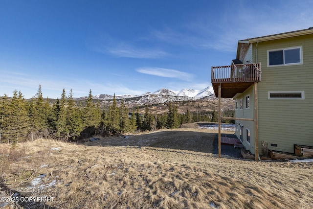 view of yard featuring a deck with mountain view