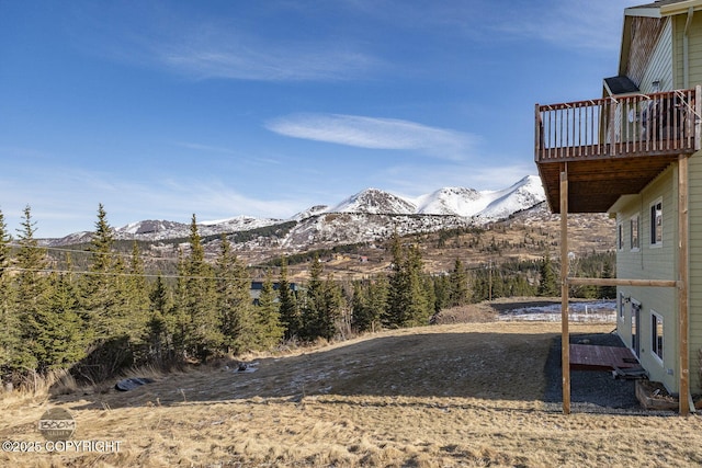 view of yard featuring a deck with mountain view