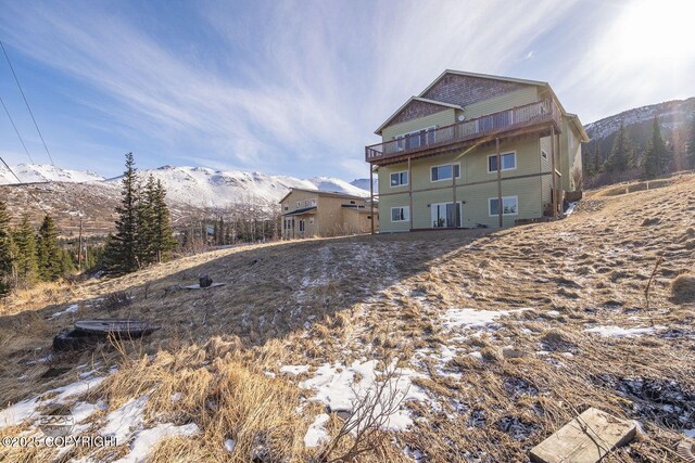 back of house with a balcony and a mountain view