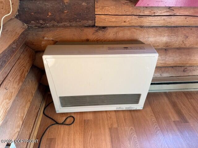 interior details featuring heating unit and log walls