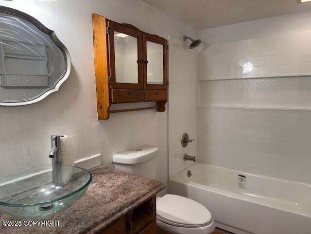 bathroom featuring toilet, tub / shower combination, and vanity