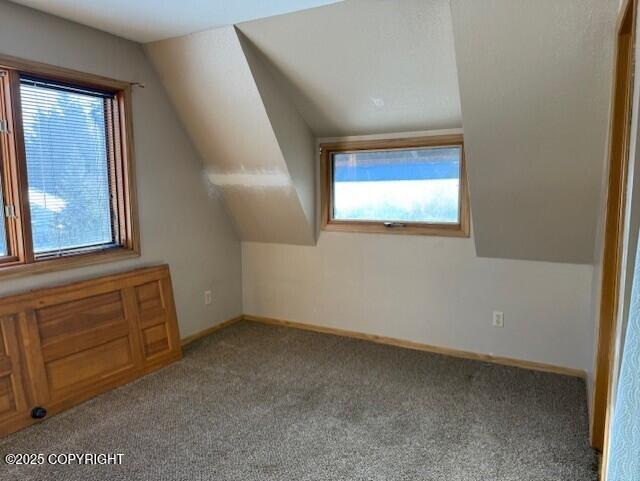 bonus room with carpet floors, lofted ceiling, and baseboards