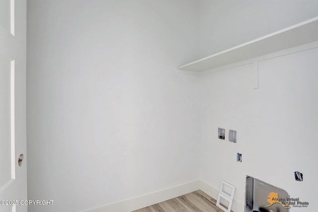 washroom featuring laundry area, baseboards, washer hookup, and light wood finished floors