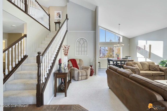 20420 Williamsburg Dr, Eagle River, AK 99577 - living room featuring high vaulted ceiling, stairway, baseboards, a chandelier, and carpet