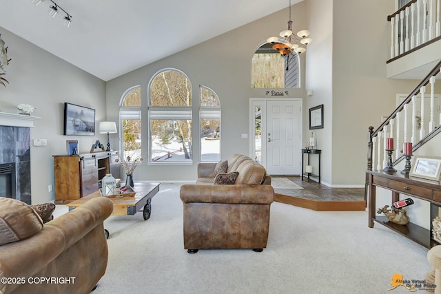 20420 Williamsburg Dr, Eagle River, AK 99577 - living room with high vaulted ceiling, a chandelier, baseboards, carpet floors, and stairs