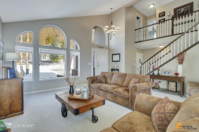 20420 Williamsburg Dr, Eagle River, AK 99577 - living room with carpet floors, a chandelier, baseboards, stairs, and high vaulted ceiling